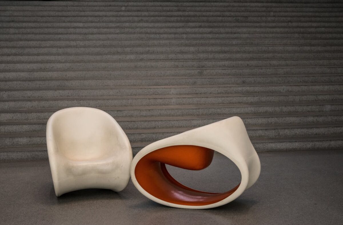 Artistic chairs in a minimalist indoor setting, showcasing modern design.
