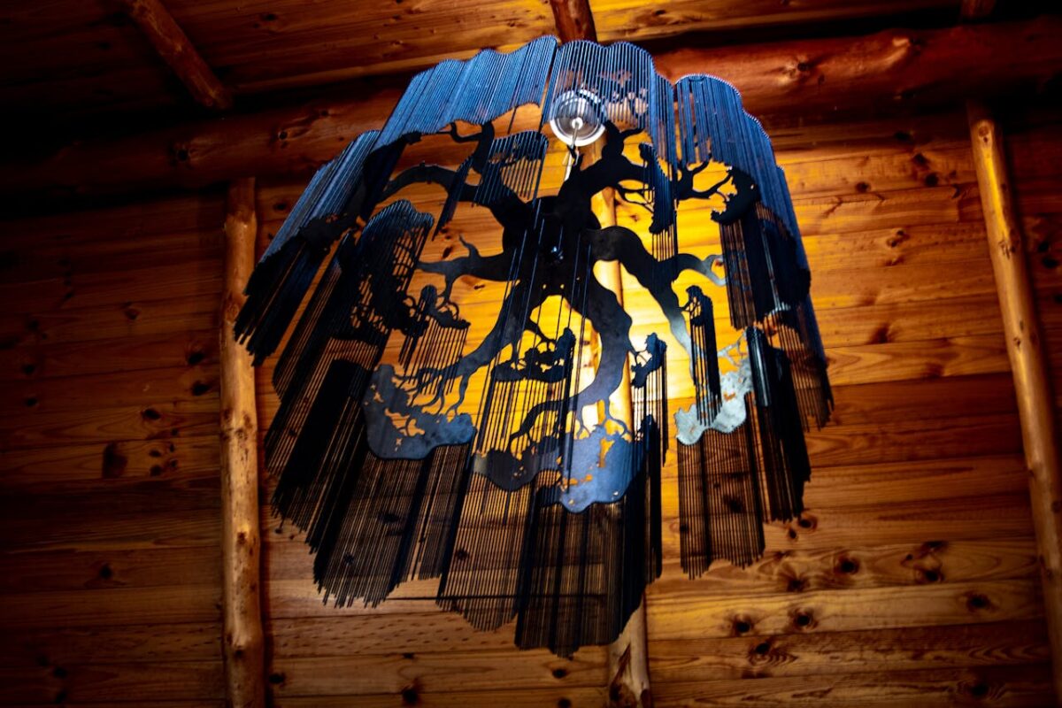 Artistic lighting fixture with a nature-inspired design in a wooden interior.